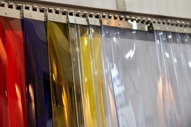 Clear, yellow, blue and red PVC strips layered on top of each other.